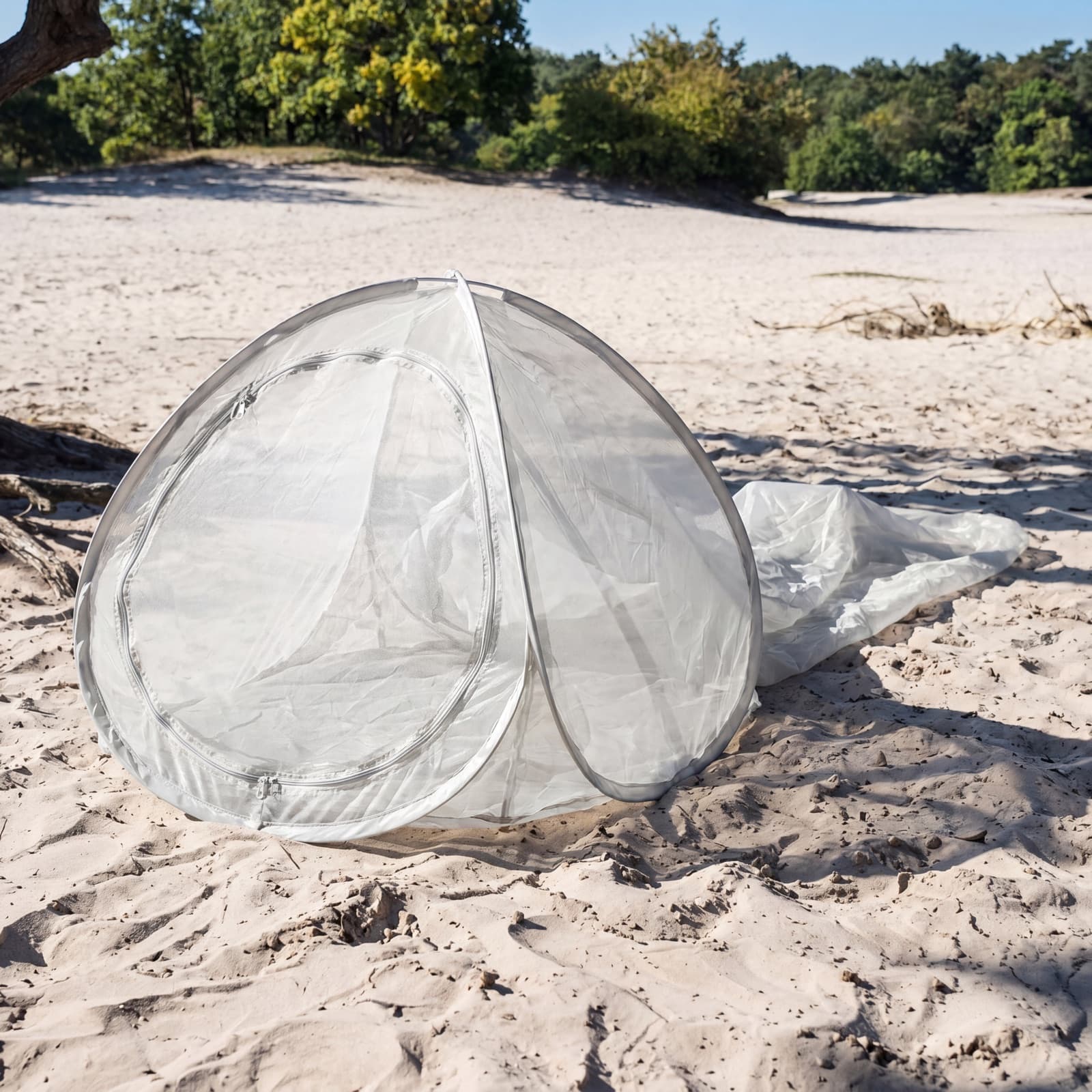 The Mosticare Domo Pop freestanding dome on a beach, showing its low pop-up profile.